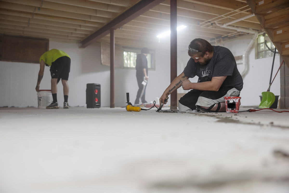 Precision Basement Waterproof team working in a basement project